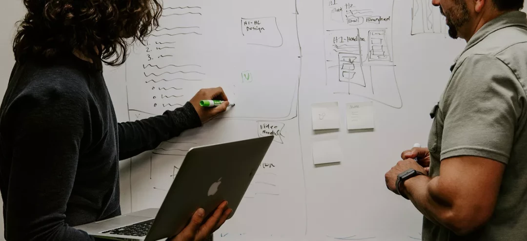 coworkers whiteboarding together