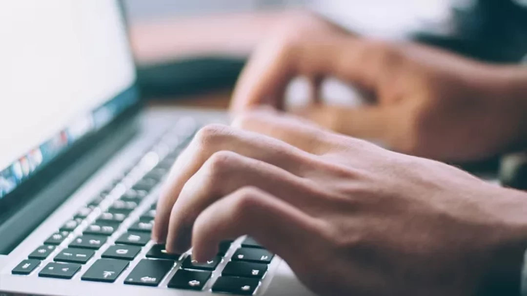 Person typing on laptop